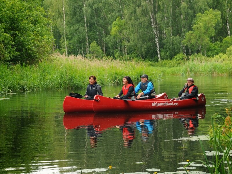 Kaks kanuud ja neli inimest peavad mõttepausi südasuviselt rohelises Eesti looduses